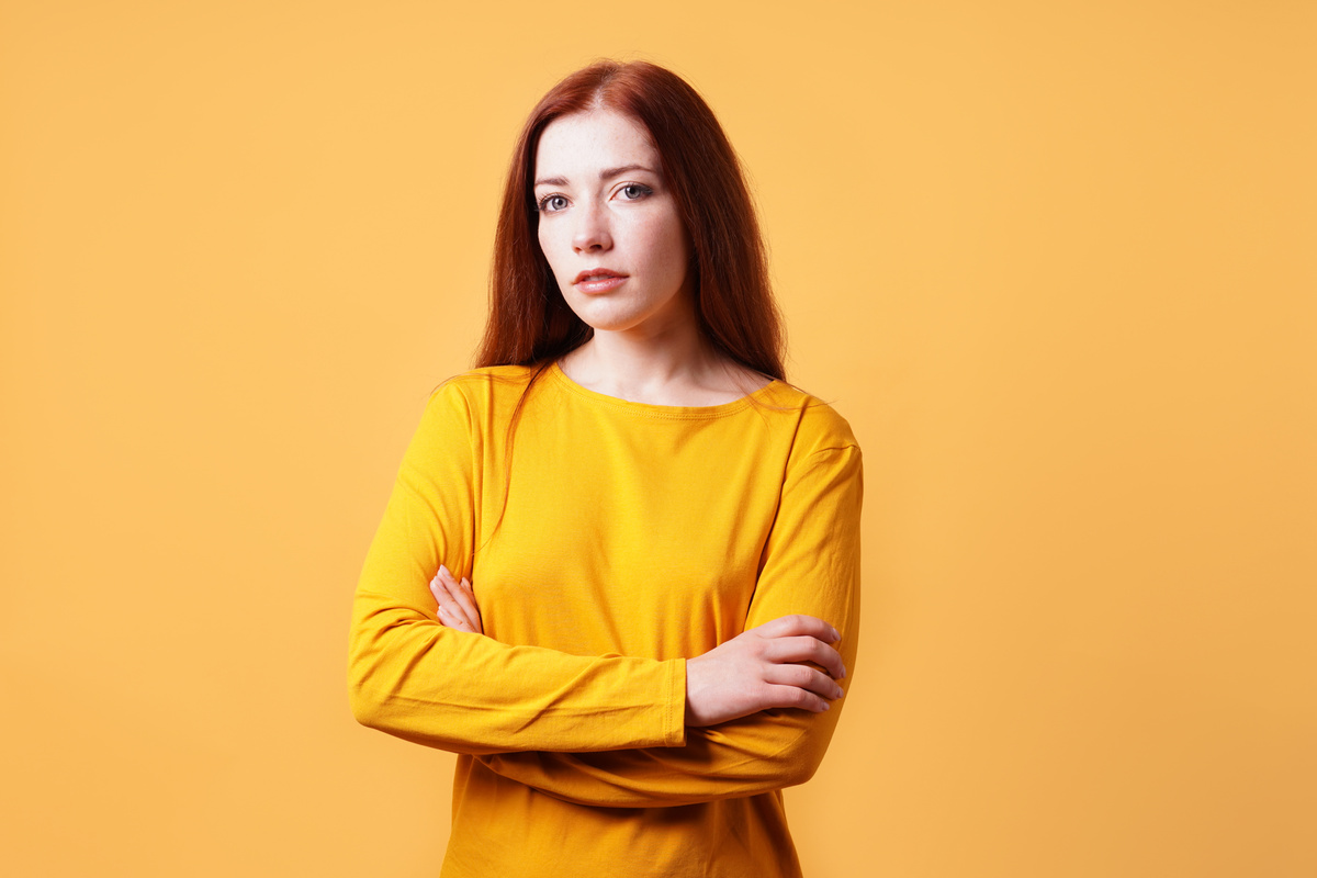 Portrait of a Woman Posing on an Orange Background